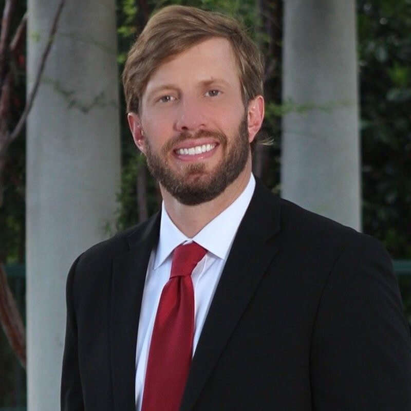 Professional Headshot of Garrett Murphy in a Suit