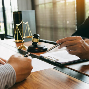 Lawyer Discussing With Client at Desk